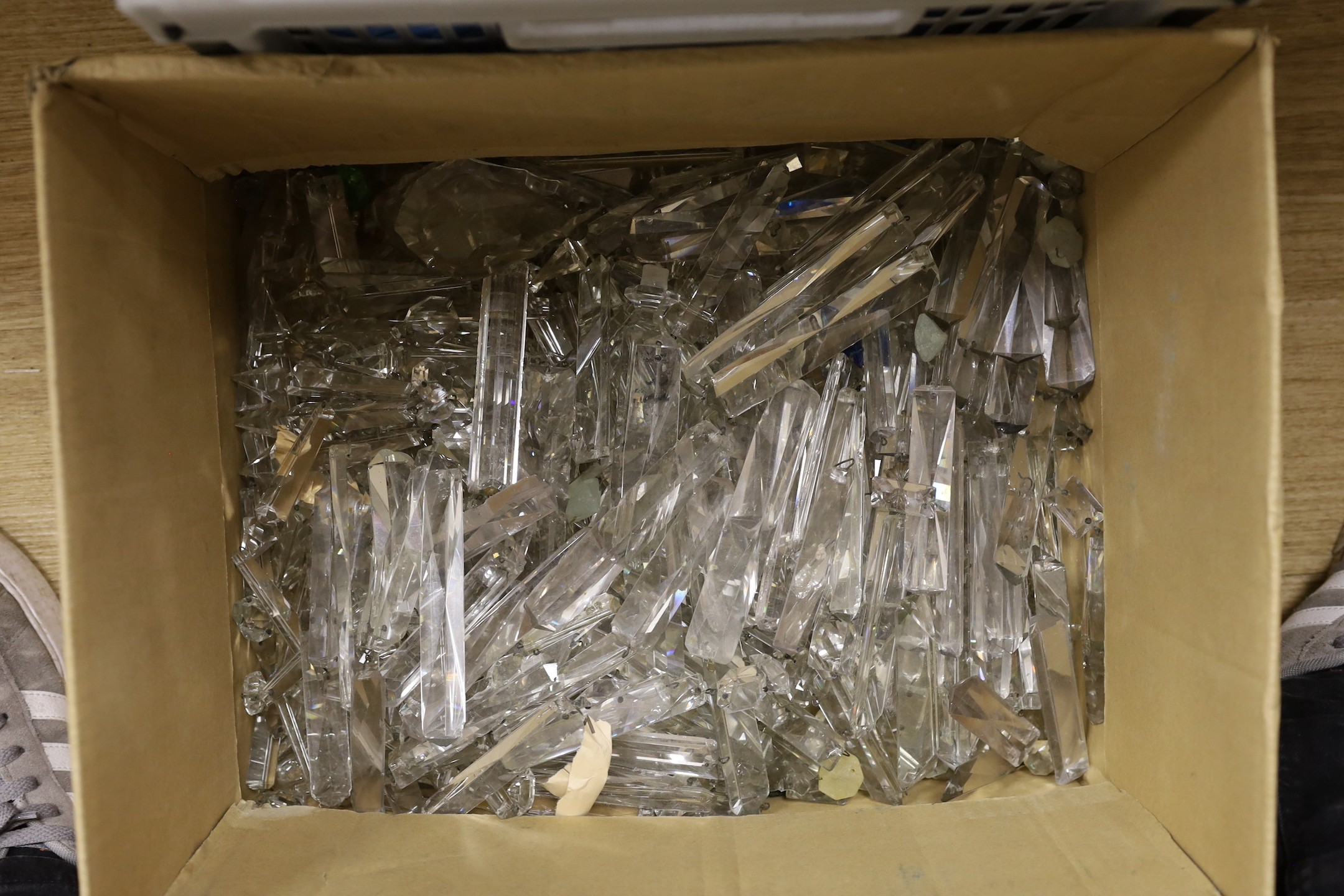 A large group of cut glass chandelier parts and prismatic cut drops